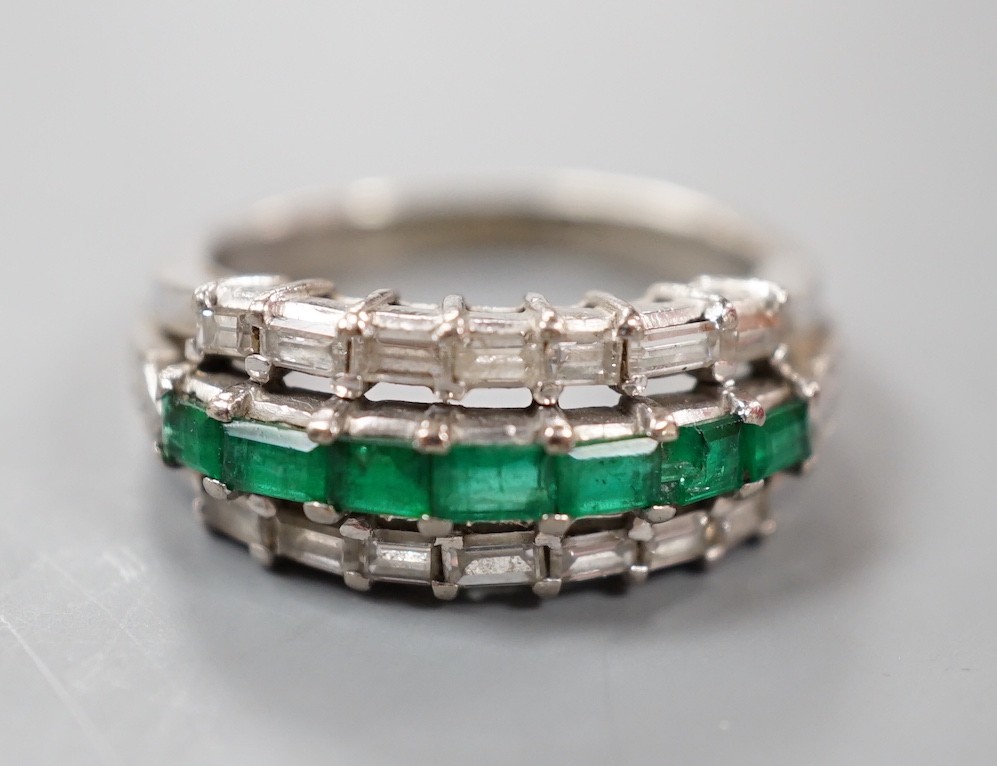A modern 18k white metal, emerald and baguette cut diamond set three row half hoop ring (shank cut), size L, gross weight 5 grams.